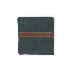 a folded piece of cloth on a white surface with a brown stripe in the middle