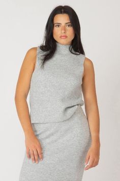 Soft + comfy + oh so chic. Our sleeveless mock neck sweater by Black Tape is a must have for your cold weather wardrobe. It has a subtle rib knit pattern + hits at the natural waist for a flattering fit. Pair it with our coordinating midi sweater skirt for an easy + ready to go outfit perfect for work or brunch. 98% polyester / 2% spandex Midi Sweater Skirt, Mockneck Sweater, Skirt Model, Black Tape, Fully Fashioned, Chic Sweaters, Mock Neck Top, Outfit Making, Sweater Tank