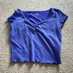 This Hollister Shrunken Cropped Tee Is Never Worn And Is In Great Condition With No Rips Or Stains. It’s A Purple/Blue Color And A Size Small. Fitted Purple T-shirt For Spring, Y2k Style Stretch Blue Tops, Casual Purple Crew Neck Crop Top, Purple Stretch Crew Neck Top, Purple Y2k Crew Neck Top, Y2k Short Sleeve Blue Top, Purple Stretch Crop Top With Short Sleeves, Blue Y2k Short Sleeve Top, Y2k Blue Short Sleeve Top