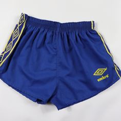 Vintage 80s Umbro Nylon Soccer Shorts Soccer Shorts Brand New Comes From A Smoke-Free Household. Youth Medium 2 Inch Inseam 11 Inch Waist Lying Flat 10 Inch Overall Length Youth Large 2 Inch Inseam 11.5 Inch Waist Lying Flat 10.5 Inch Overall Length Blue And Yellow 50% Cotton 50% Polyester Check Out My Other Items For Sale In My Store! Box 5 80s Athletic Fashion Men, Retro Blue Short Bottoms, Vintage Blue Sports Shorts, Blue Stretch Vintage Bottoms, Vintage Stretch Blue Bottoms, Vintage Blue Stretch Bottoms, Blue Vintage Stretch Bottoms, 80s Athletic Fashion, Brazil Soccer