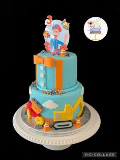 a three tiered cake with an image of a cartoon character on top