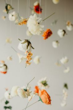 an arrangement of flowers hanging from the ceiling