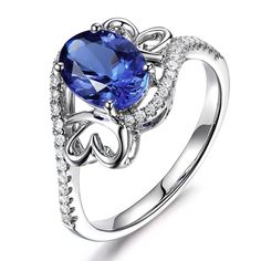 an oval blue sapphire and diamond ring on a white background