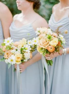 the bridesmaids are holding their bouquets together