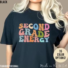 Cute Teacher Shirt, Second Grade Energy Shirt, Shirt for Second Grade, Teacher Appreciation Shirt, Best Teacher Shirt 💥 We have 16 colors available, with the option to choose from up to 35 colors. If you are interested in other colors, please contact us. 💫Dual side seams hold the garment's shape for longer. 💫100% Airlume combed and ringspun cotton (fiber content may vary for different colors) 💫Light fabric 💫Runs true to size. 📢 Contact us if you need more information: 👉🏿Designed specifically for individuals, companies, groups, families, or any customized idea on a shirt. 👉🏿Buy a quantity of 10 shirts or more to receive the appropriate discount code. 👉🏿If you have any questions or if you have received a product that is unsatisfactory, please reach out to us. 💥 Please make sure Retro Relaxed Fit Tops For School, School Spirit Shirt With Graphic Print, School Spirit Graphic Print Relaxed Shirt, School Spirit Graphic Print Relaxed Fit Shirt, School Spirit Slogan Top With Relaxed Fit, School Spirit Slogan Top In Relaxed Fit, Multicolor Long Sleeve Pre-shrunk Shirt, Relaxed Fit Tops With School Spirit Slogan, Retro Black Top For School