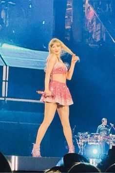 taylor swift performing on stage at a concert