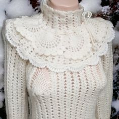 a mannequin wearing a white knitted sweater