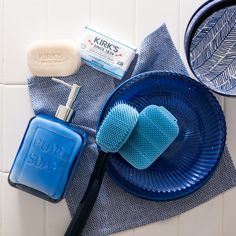 a blue plate topped with soap and other items