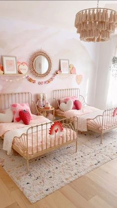 a white bed with pink and brown pillows