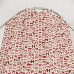 a red and white curtain with bows on it