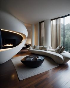 a living room with a large white couch and fireplace in the corner next to it