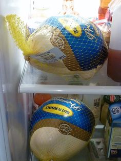 there are two large balls in the refrigerator, one is blue and yellow with gold on it