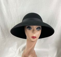 This classic black wool felt lampshade hat has a 4 1/2 inch brim all around. The hat will fit up to a 22- 22 1/2  inch head size. The black grosgrain ribbon is removable if you would like to put another band on. NOTE: Please check the head size before purchase, I am happy to answer any questions you may have. There will be a 20% restocking fee for all returned hats. Cheap Black Hats For Gifts, Affordable Black Classic Felt Hat, Luxury Black Short Brim Hat, Cheap Playful Black Hats, Playful Cheap Black Hats, Luxury Black Felt Hat For Formal Occasions, Luxury Black Felt Hat, Luxury Black Hats For Cold Weather, Cheap Black Casual Felt Hat