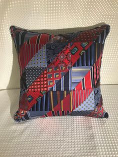 a decorative pillow made out of different colored fabrics