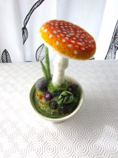 a small mushroom sitting on top of a white table