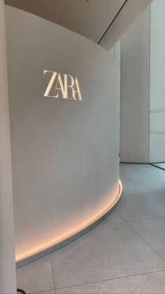 the entrance to zara is lit up in white and has an illuminated sign on it