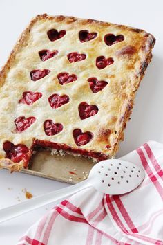 a piece of pie with hearts cut out of it and a spatula next to it