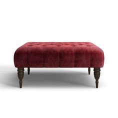 a red velvet bench with wooden legs on an isolated white background for display or montage