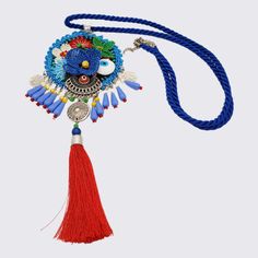 A central medallion depicts a beautiful scene of flowers in vibrant colors. Beads of different shapes and textures dangle among intricate open-work charms. The look is finished with a luxurious dangling tassel. Each piece is crafted from a combination of felt, delicate needle lacework and beads. Pair these stunning necklaces with a plain white shirt that will make it the focal point of your look. Add a wow-factor to your little black dress and create a carefree style-statement with jeans and a b Multicolor Bohemian Medallion Beaded Necklaces, Multicolor Bohemian Medallion Beaded Necklace, Blue Bohemian Medallion Necklace, Bohemian Blue Medallion Necklace, Blue Tasseled Jewelry As Gift, Blue Tassel Jewelry Gift, Blue Tassel Jewelry As Gift, Blue Tasseled Jewelry For Gift, Blue Bohemian Tassel Necklace For Gift