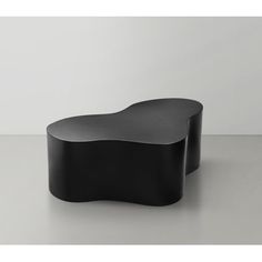 a black table sitting on top of a white floor