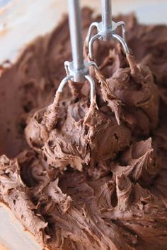 a mixer with chocolate frosting in it