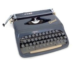 an old fashioned typewriter sitting on a white surface