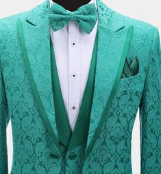 This men's three-piece green damask tuxedo is sure to get you noticed at your next formal affair. This fancy outfit is finely handcrafted from a high-quality material with a delicately textured damask design. This elegant tuxedo set comes with a patterned blazer, a matching vest, and dress pants. The contrasting peak collar, buttons, and pocket piping all provide added class and interest to this set. The lightweight fabric is soft and comfortable as well as stain-resistant. The vest/waistcoat ha Green Tuxedo With Suit Collar For Wedding, Green Tuxedo Suit For Wedding, Green Tuxedo Style Three-piece Suit For Wedding, Green Fitted Elegant Sets, Elegant Brocade Tuxedo For Wedding, Elegant Tailored Brocade Suit, Tailored Brocade Suit For Semi-formal Occasions, Fitted Green Tuxedo For Wedding, Fitted Green Tuxedo For Groom