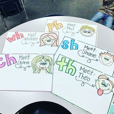 some children's handwritten name tags on a white table with chairs in the background