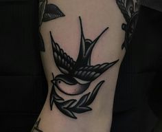 a black and white bird tattoo on the foot