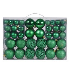 green ornaments in a clear box on a white background