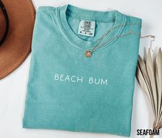 Beach Bum Shirt, Retro Comfort Colors T-Shirt, Trendy Beach Shirts for Women, Summer Vacation Shirts, Womens Oversized Beach Shirt HOW TO ORDER 1. Check and review all photos (including colors and sizes) 2. Select Your tshirt size and t-shirt color from drop down menu 3. Select quantity 4. Click ADD TO CART. For multiple items go back and repeat. IF THE ITEM HAS CUSTOMIZATION Make sure to specify in the customization box what you'd like. The more detail the better! GROUP LISTINGS If its a group Beach Themed Shirts, Beach Shirts Vinyl, Ice Cream Cups, Shirts Vinyl, Shirt Quotes, Trendy Beach, Beach Color, Beach Shirt, Vacation Shirts