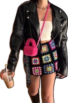 a woman in black jacket and skirt holding a pink purse