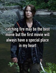 a woman holding a knife in her hand with the caption catching fire may be the best movie but the first movie will always have a special place in my heart