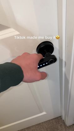 a person is pressing the button on a door handle