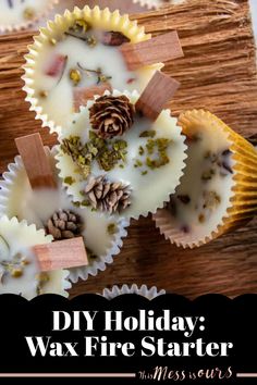 some cupcakes with white frosting and pine cones in them on a wooden table