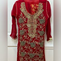 This Stunning Pakistani Style Dress Is Perfect For Any Special Occasion, From Weddings To Parties. The Intricate Embroidery And Vibrant Colors Make It A Must-Have For Anyone Looking To Make A Statement. Made With The Highest Quality Materials, This Dress Is Sure To Impress. The Dress Is Designed In Traditional Pakistani Style, With A Beautiful Salwar Kameez Silhouette. The Embroidery Is Done By Skilled Artisans, Ensuring That Every Detail Is Perfect. Whether You're Looking To Impress At A Wedding Or Simply Want To Add Some Flair To Your Wardrobe, This Dress Is The Perfect Choice. Semi-stitched Gold Dress With Floral Embroidery, Fitted Traditional Organza Dress, Long Sleeve Organza Dresses For Festivals, Fitted Embroidered Dress For Wedding, Anarkali Embroidered Dress Fitted For Formal Occasions, Fitted Anarkali Embroidered Dress For Formal Occasions, Bollywood Style Dress With Gold Embroidery In Organza, Bollywood Style Organza Dress With Gold Embroidery, Elegant Red Kurta For Wedding