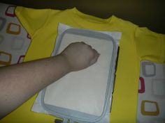 a person laying on top of a yellow shirt