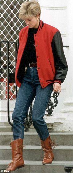 a woman walking down some steps wearing boots and a red jacket with black sleeves on