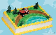 a birthday cake with a red car driving over a river on top of a book