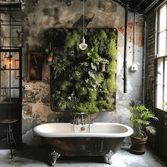 An industrial bathroom with a variety of potted plants and a living wall, adding a pop of green to the neutral space4