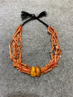 The necklace is made with strands of small branches of coral and Old natural amber beads . This type of jewelry is used by women who live in the region of the Anti-Atlas of Morocco. Necklace éléments : Old Natural Amber beads Antique Natural Coral Beads from Morocco. Length of the necklace : 55cm Weight : 156g Unique Hand-strung Orange Necklace, Traditional Orange Necklace With Natural Stones, Traditional Multi-strand Red Coral Necklaces, Traditional Multi-strand Red Coral Necklace, Unique Orange Necklace With Polished Beads, Artisan Hand-strung Red Coral Necklace, Traditional Multi-strand Red Coral Beaded Necklace, Artisan Red Coral Beaded Necklace With Polished Beads, Unique Red Coral Beaded Necklaces With Large Beads