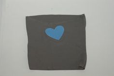 a blue heart is on the back of a gray t - shirt