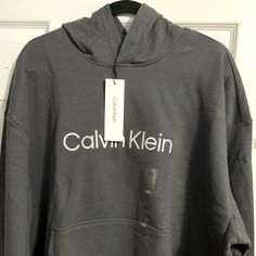 New With Tags Gray Calvin Klein Hooded Cotton Sweater Calvin Klein Winter Sweatshirt With Ribbed Cuffs, Calvin Klein Casual Cotton Outerwear, Calvin Klein Cotton Outerwear For Fall, Calvin Klein Crew Neck Winter Sweatshirt, Calvin Klein Crew Neck Sweatshirt For Winter, Casual Winter Hoodie With Logo Print, Calvin Klein Cotton Hoodie For Fall, Calvin Klein Logo Print Sweatshirt For Fall, Calvin Klein Hooded Sweatshirt For Fall