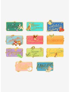 nine different colored enamel name tags on white background