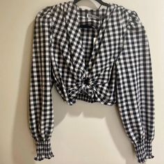 Black And White Gingham Long Sleeve Blouse With Puffy Sleeves And Smock Trim. Deep V Neckline With An Open Circle Knot Detail In The Center. Really Flattering. Never Worn New With Tags. Size Small. Trendy Fitted Gingham Blouse, Chic Plaid Blouse For Picnic, Chic Gingham Long Sleeve Tops, Chic Gingham Blouse For Brunch, Plaid Long Sleeve Blouse For Day Out, Chic Gingham Long Sleeve Blouse, Chic Long Sleeve Gingham Blouse, Chic Gingham Blouse For Fall, Fall Gingham V-neck Top