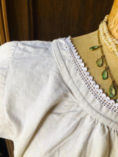 Antique smock dress dating from the early 1900s .  Pretty,  simple off white (oatmeal cream) linen dress with short sleeves and simple lace trim. A sister dress - one of two matching tunics available. The linen is robust - medium weight linen - a little stiff but will soften up with wear and washing. Small hand stitched monogram in the centre. This old linen takes dye very well if you fancy another colour! SIZE:large  - when laid flat armpit to armpit across the chest 54cm (21")     length 107cm Vintage Short Sleeve Sleepwear With Lace Trim, Feminine V-neck Chemise With Lace Trim, Cream Linen Dress, Lace Trim V-neck Chemise, Casual V-neck Lace Trim Nightgown, Casual V-neck Nightgown With Lace Trim, Chemise Dress, Sisters Dress, Cream Lace