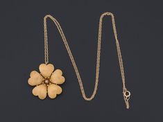 A golden blossom to liven up any ensemble. This charming pendant was originally an antique brooch (circa 1900-1915) transformed by removing the pin findings. The flower is solid gold with beautifully textured petals and stylized anthers encircling the center diamond for an added dramatic effect. The pendant measures 0.9 inches in diameter, and is unmarked, but acid tests for 14k gold. We are providing the option to purchase the pendant with or without the 18 inch 10k gold chain depicted in the a Elegant Flower Pendant Brooch Jewelry, Antique Gold Flower Jewelry, Elegant Flower Pendant Brooch, Gold Heirloom Jewelry In Flower Shape, Heirloom Gold Jewelry With Flower Shape, Heirloom Gold Jewelry In Flower Shape, Antique Formal Jewelry With Flower Pendant, Antique Flower Pendant Jewelry For Formal Occasions, Gold Flower Pendant Brooch Jewelry