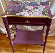 a purple table with flowers painted on it