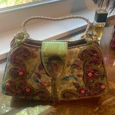 Authentic Mary Frances Handbag. It Is In Good Condition, No Stains Or Pulls. The Handle Is The Only Issue. The Strand Of Beads Pulled But Can Be Fixed Or Tied Off And Cut. Still A Lot Of Wear To This Bag. I Loved It Very Much Just Time To Rotate The Closet Luxury Handheld Beaded Shoulder Bag, Elegant Multicolor Handheld Satchel, Formal Beaded Shoulder Bag With Top Handle, Formal Beaded Top Handle Shoulder Bag, Vintage Embellished Pouch Bag, Pink Embellished Top Handle Bag, Designer Embellished Bags For Shopping, Designer Embroidered Rectangular Bag, Elegant Embellished Travel Bags