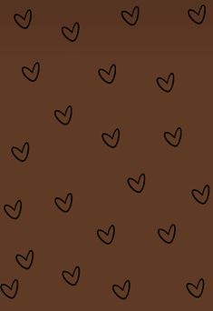 a brown background with black hearts on the left and right hand corner in the middle